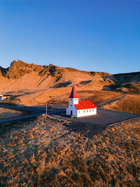 Scenic view of mountains and church against clear blue sky