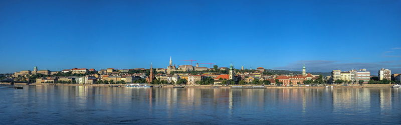 Panoramic view of the danube river and the embankment of buda on a sunny summer morning