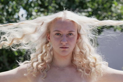 Close-up portrait of shirtless man with blond hair