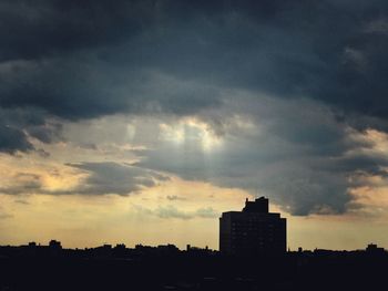 Silhouette cityscape against sky during sunset
