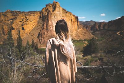 Rear view of woman against clear sky