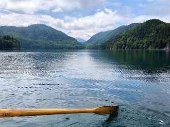Scenic view of lake by mountains against sky
