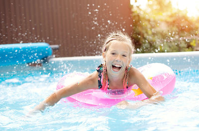 Portrait of boy swimming in pool