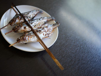 Grilled fish skewers in mekong river . thaifood