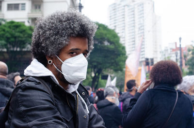 Portrait of man standing in city