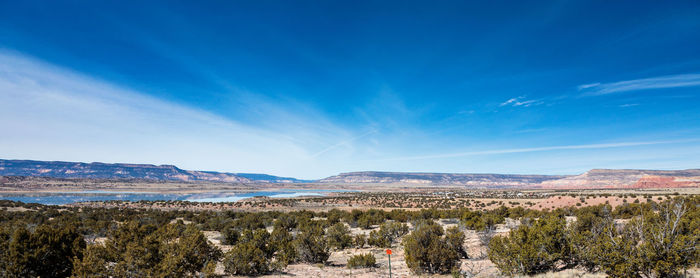 Panoramic view of landscape against blue sky