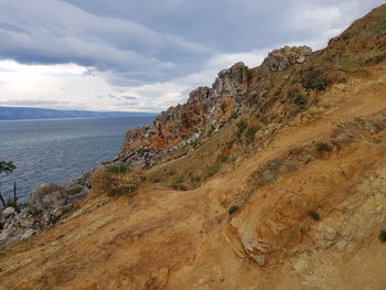 Scenic view of sea and mountains against sky