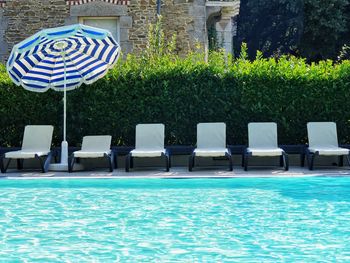 Chairs on swimming pool
