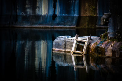 Broken ladder by lake