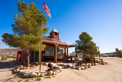 Gazebo by building against clear blue sky