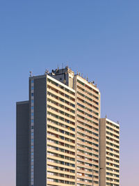 Low angle view of modern building against clear blue sky