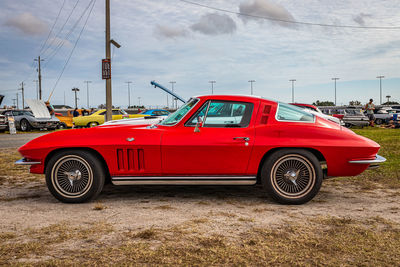 Vintage car parked against cloudy sky