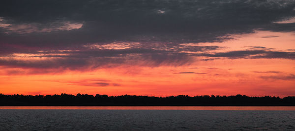 Scenic view of sea against orange sky