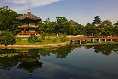 Photo of buildings and lake at the royal palace gyeongbokgung / seoul