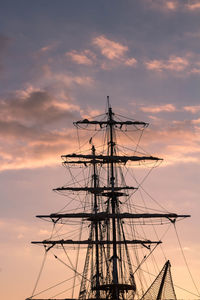 Low angle view of silhouette sailboat against sky during sunset