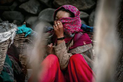 Portrait of woman covering face