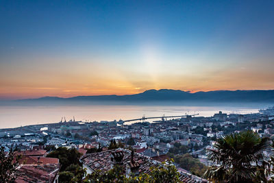 High angle view of town against sky during sunset