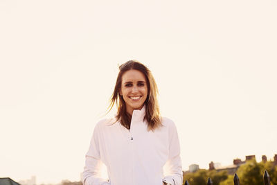 A backlit portrait of an athletic female.