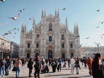 Group of people against the church of duomo in milan, italy