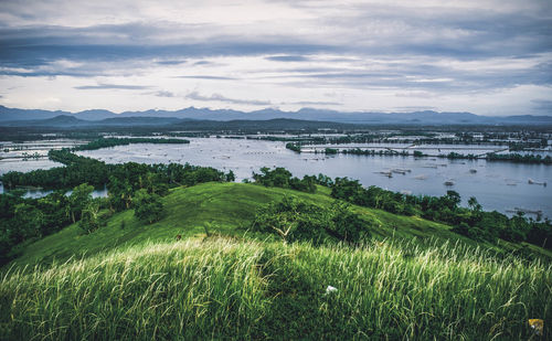 Scenic view of land and sea against sky