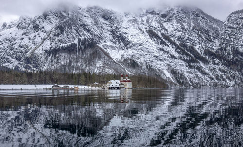 Scenic view of lake by snowcapped mountains