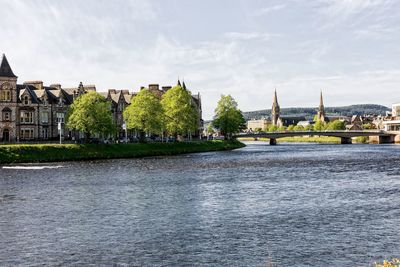 River amidst buildings against sky