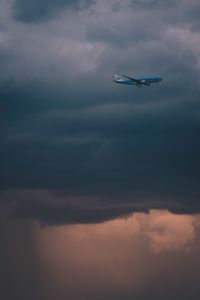 Low angle view of airplane flying in sky
