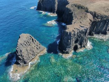 High angle view of rocks in sea