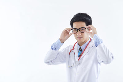 Young man standing against white background