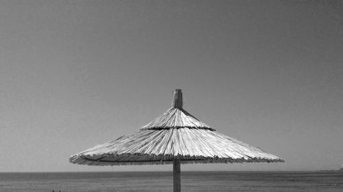 Thatched beach umbrella against clear sky