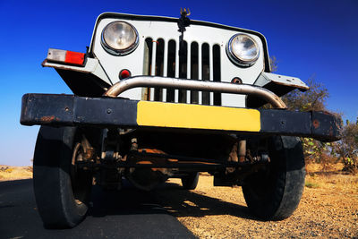 Low angle view of off-road vehicle on road