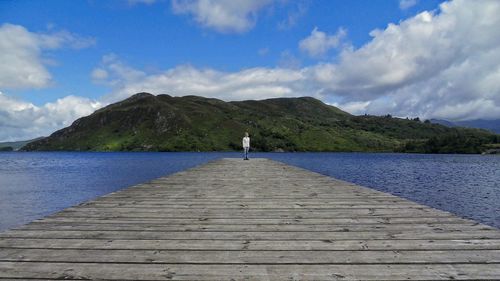 Pier over lake against sky