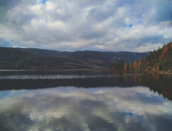Scenic view of lake and mountains against sky