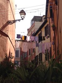 Clothes drying on balcony against houses in city