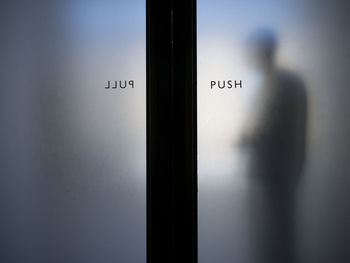 Man standing by closed grass door