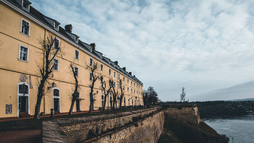 Low angle view of building by street against sky