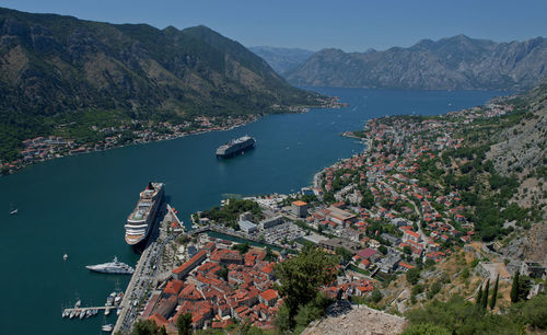 High angle view of ships sailing in river by city