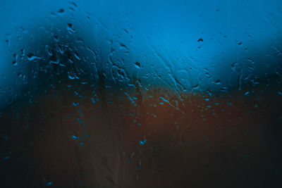 Full frame shot of raindrops on glass window