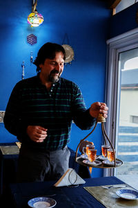 Waiter serving tea in armenian restaurant