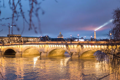 View of bridge over river at night