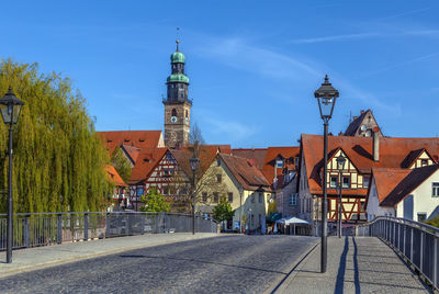 View of buildings in city against blue sky