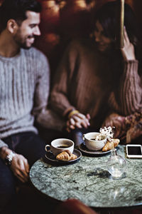 Smiling man holding hands with female partner in hotel