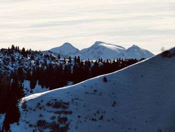 Scenic view of snow covered mountains against sky