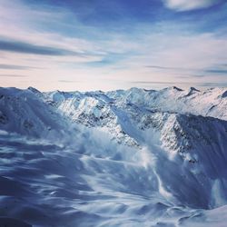 Scenic view of snow mountains against sky