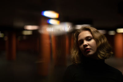 Portrait of young woman in garage