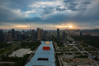 High angle view of buildings in city during sunset