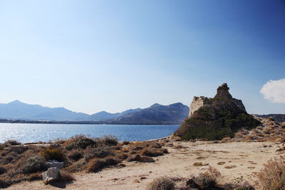 Scenic view of sea and mountains against clear sky