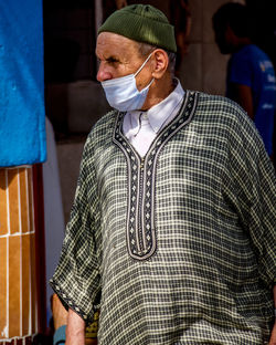 Full length portrait of young man standing outdoors