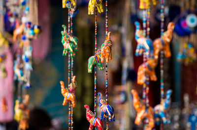 Colorful figurines hanging at market for sale