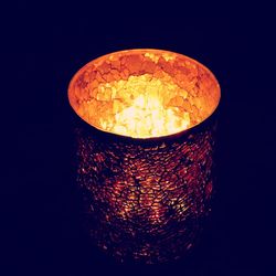 Close-up of illuminated lamp against black background